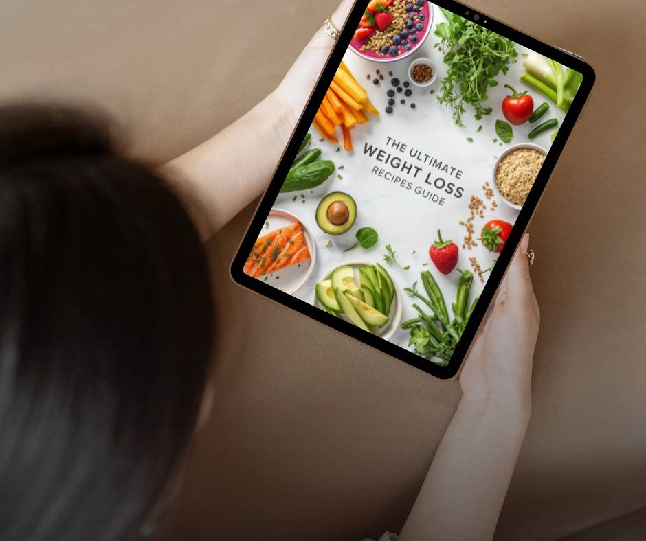 Tablet displaying "Ultimate Weight Loss Recipes Guide" surrounded by healthy foods like avocado, salmon, vegetables, and berries